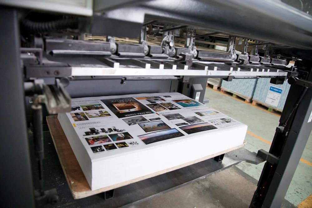Brochure pages sitting on a press delivery